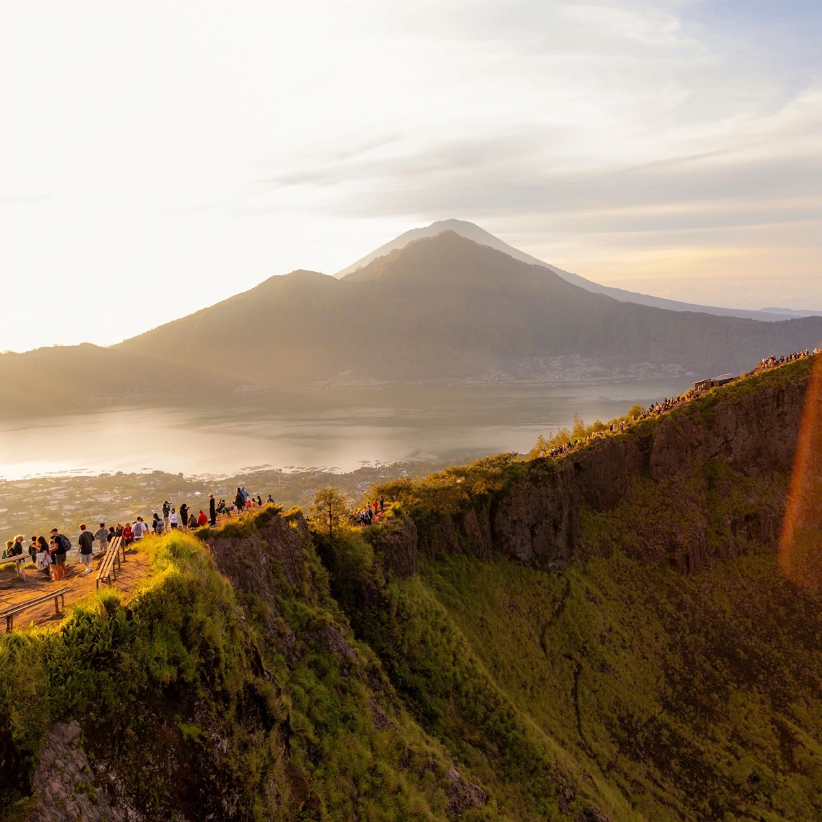Travelers watching sunrise from Mount Batur summit in Bali